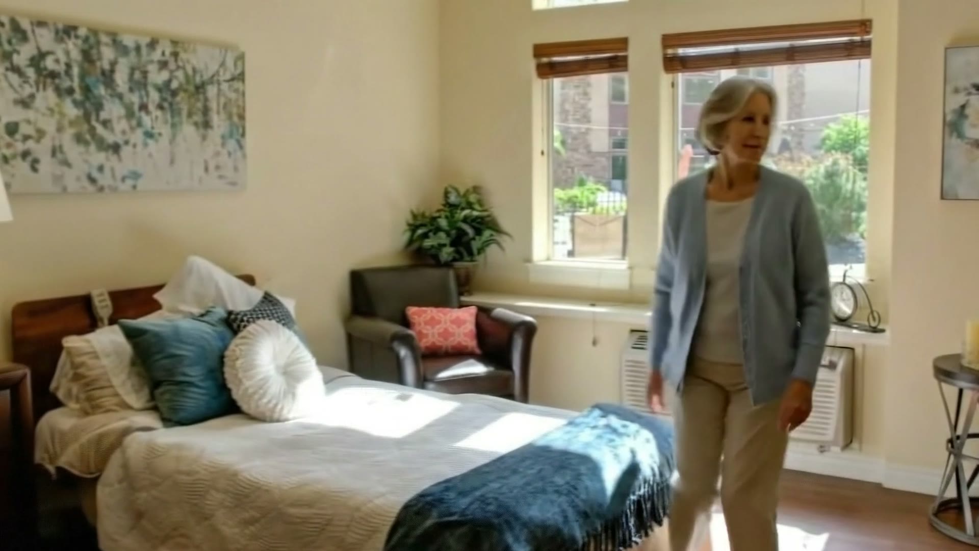 Resident walking through an assisted living apartment at Gardens on Quail