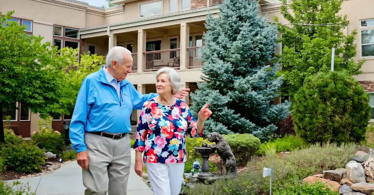 Gardens on Quail senior couple walking together through the landscaped courtyard.