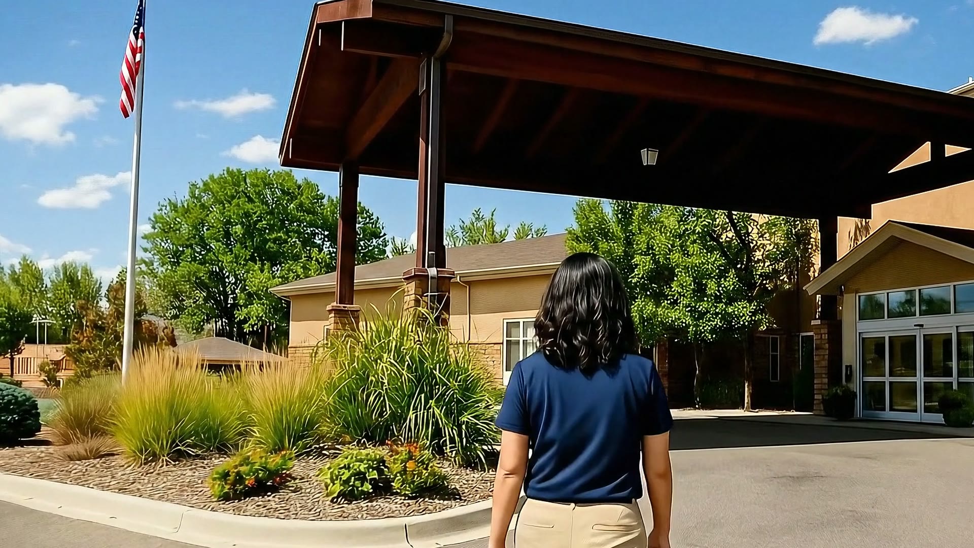 Visitor walking toward the Gardens on Quail main entrance